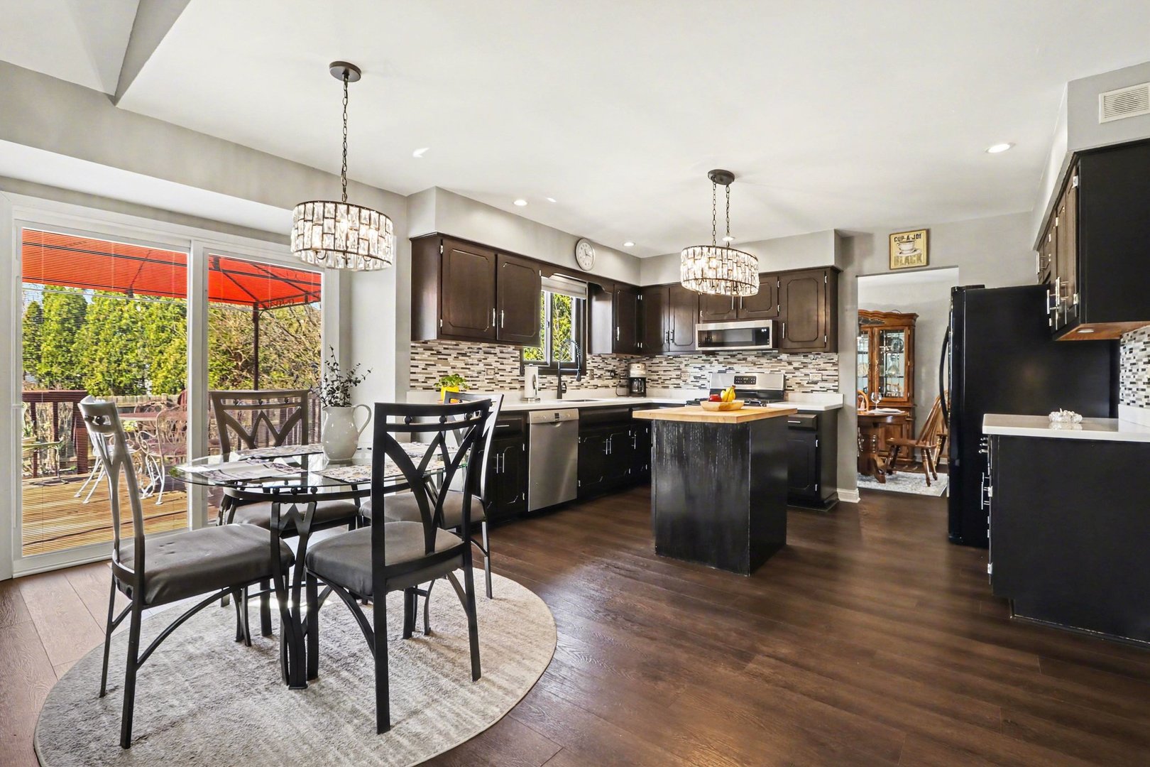 237 Homewood Drive Bolingbrook, IL 60440 - Photo 14 of 37 a kitchen with stainless steel appliances granite countertop a stove top oven a sink dishwasher a dining table and chairs with wooden floor