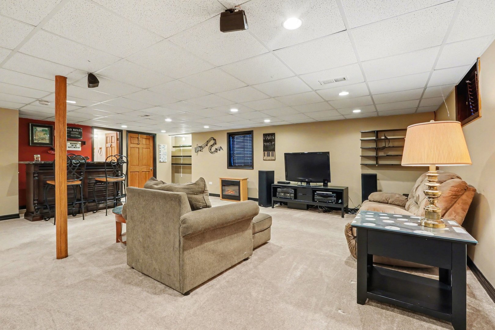 237 Homewood Drive Bolingbrook, IL 60440 - Photo 27 of 37 a living room with furniture a flat screen tv and a fireplace