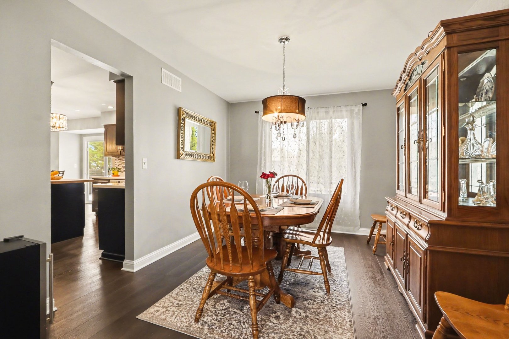 237 Homewood Drive Bolingbrook, IL 60440 - Photo 9 of 37 a dining room with furniture a chandelier and wooden floor
