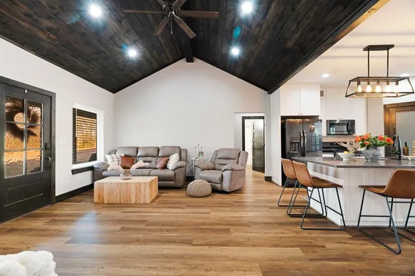 a living room with fireplace furniture and a flat screen tv