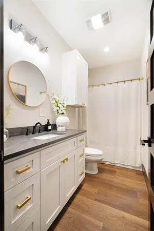 a bathroom with a double vanity sink and a mirror
