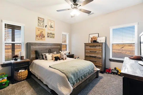 a bedroom with a bed and dresser with mirror
