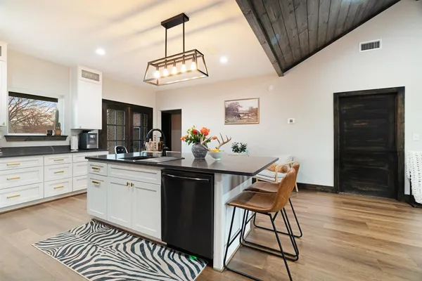 a view of a dining room with furniture wooden floor and chandelier