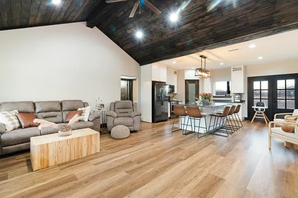 a living room with furniture and wooden floors