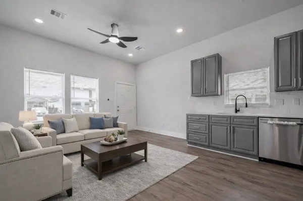a living room with furniture and wooden floor