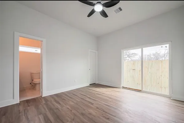 a view of a room with wooden floor closet and windows