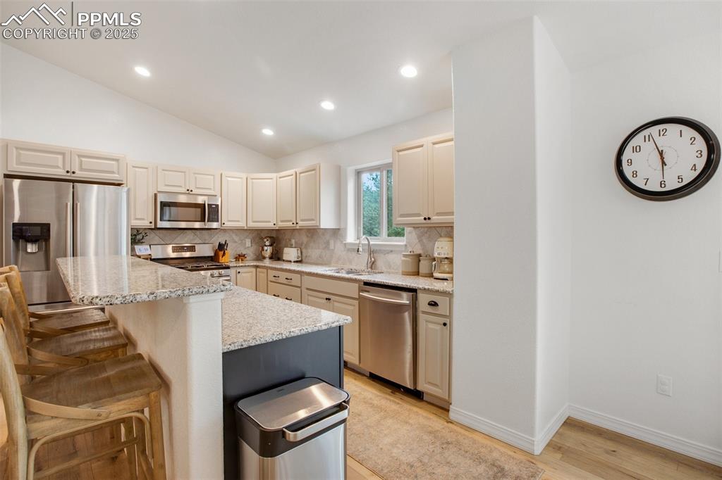 277 Aspen Circle Divide, CO 80814 - Photo 12 of 45 a kitchen with a refrigerator a stove top oven a sink and dishwasher