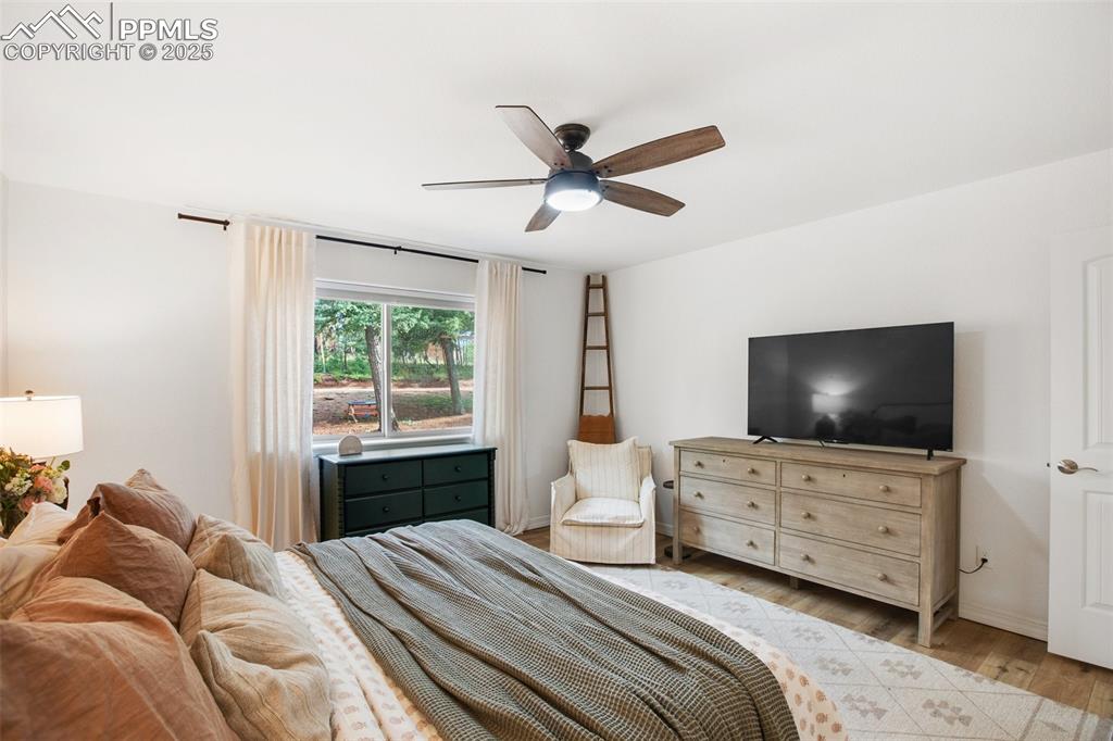 277 Aspen Circle Divide, CO 80814 - Photo 15 of 45 a bedroom with a bed and a flat tv screen on dresser