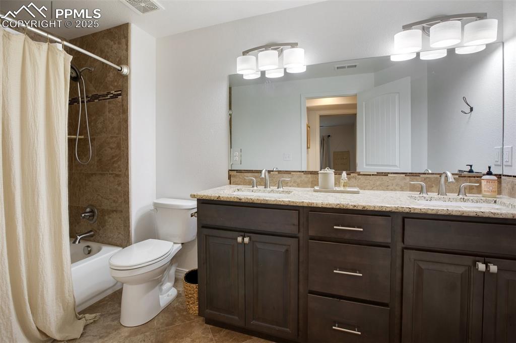 277 Aspen Circle Divide, CO 80814 - Photo 32 of 45 a bathroom with a toilet a sink and mirror