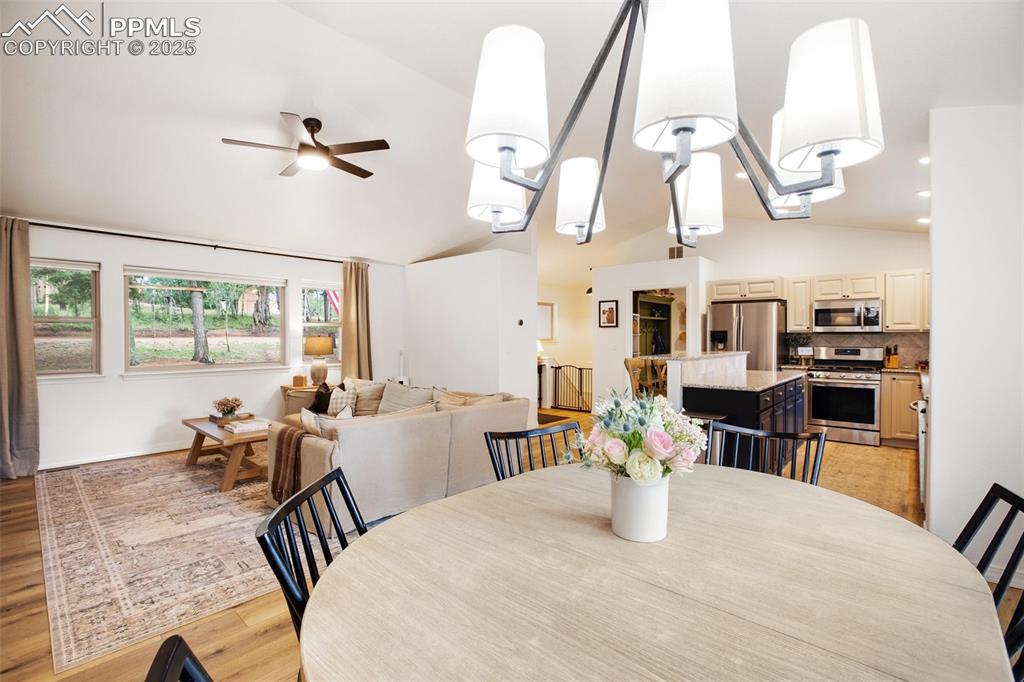 277 Aspen Circle Divide, CO 80814 - Photo 7 of 45 a dining room with wooden floor table and chairs
