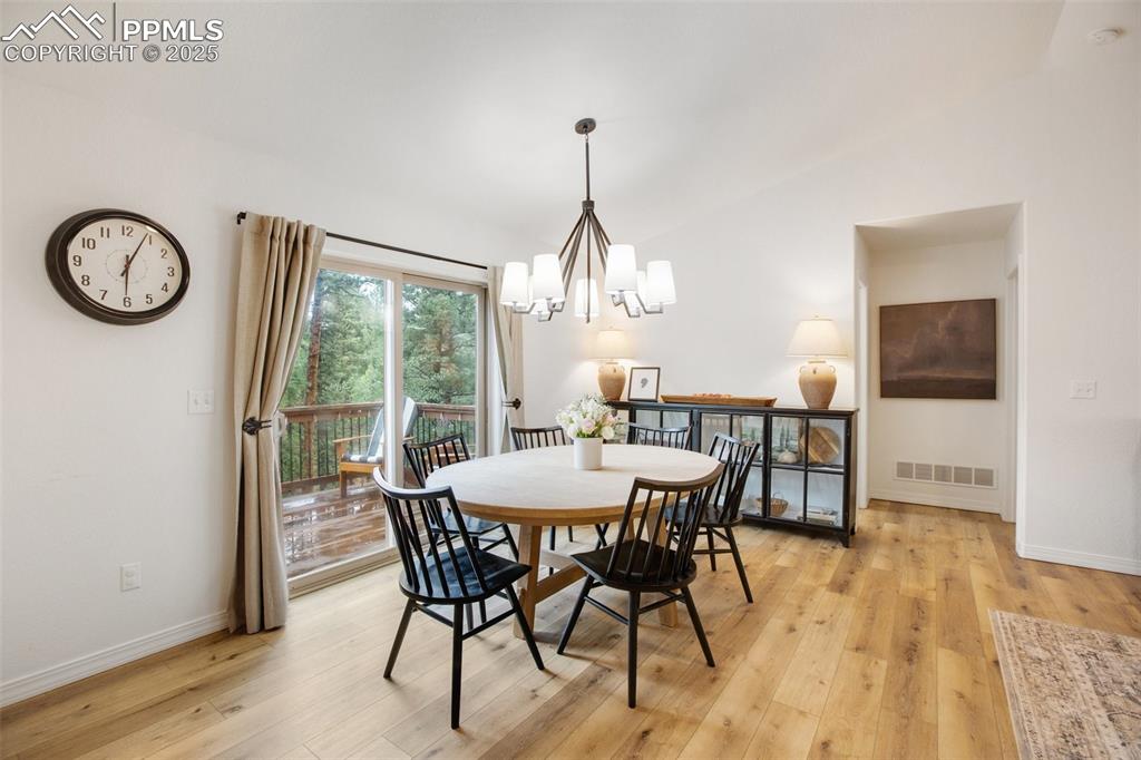 277 Aspen Circle Divide, CO 80814 - Photo 8 of 45 a view of a dining room with furniture window and wooden floor