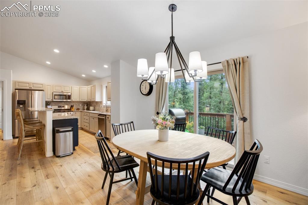 277 Aspen Circle Divide, CO 80814 - Photo 9 of 45 a dining room with furniture a chandelier and wooden floor