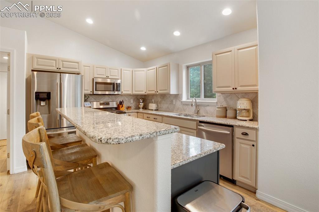 277 Aspen Circle Divide, CO 80814 - Photo 10 of 45 a kitchen with kitchen island granite countertop a sink counter top space appliances and cabinets