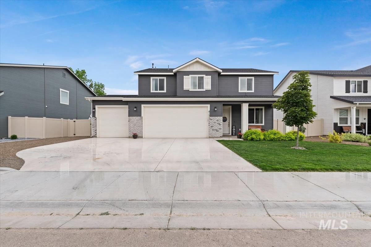 815 Knowledge Street Middleton, ID 83644 - Photo 41 of 49 Two-story residence featuring a dark gray facade with white trim accents and a white front door