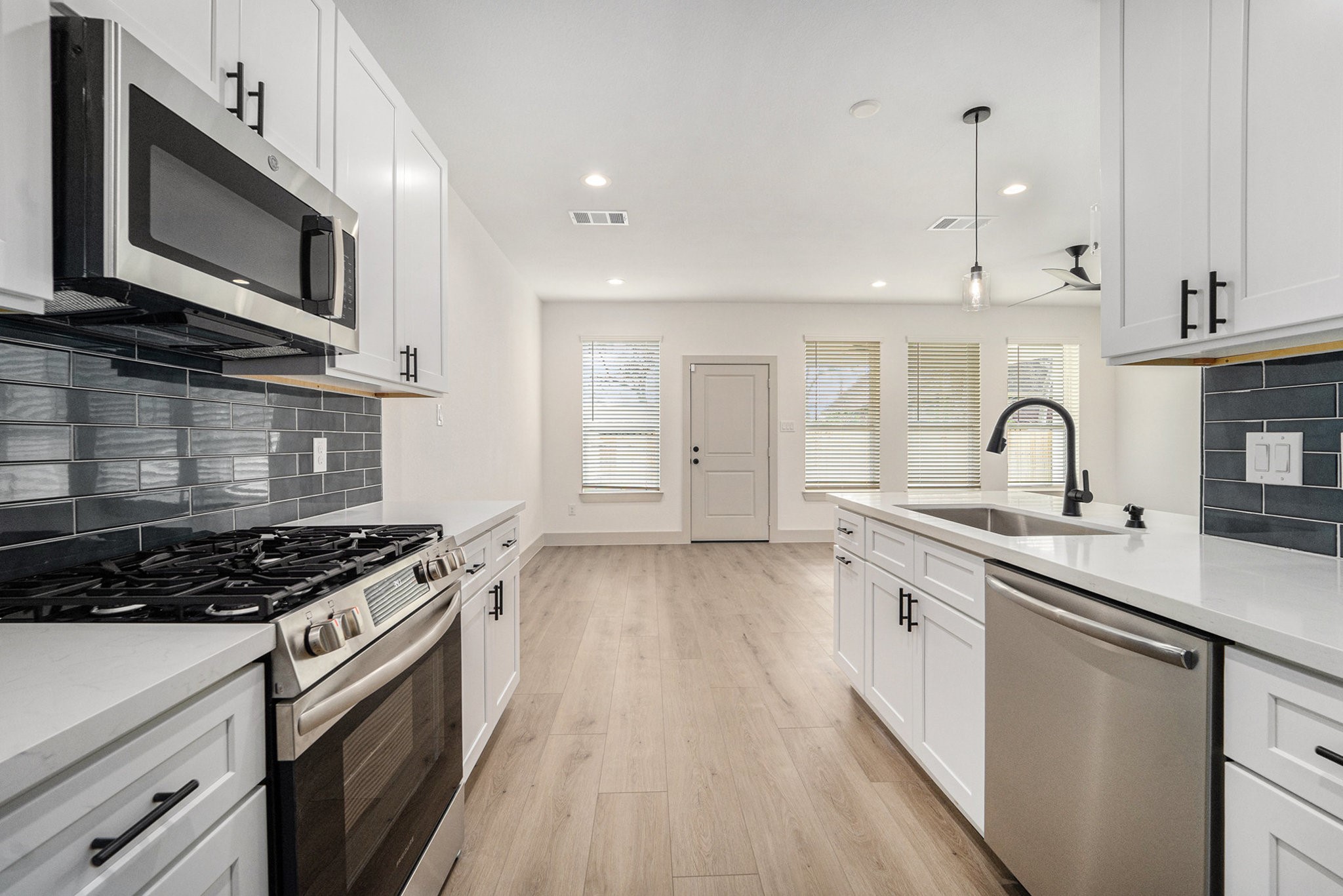 6425 Anderson Road, Unit B Houston, TX 77085 - Photo 11 of 36 a kitchen with stainless steel appliances a sink stove and cabinets