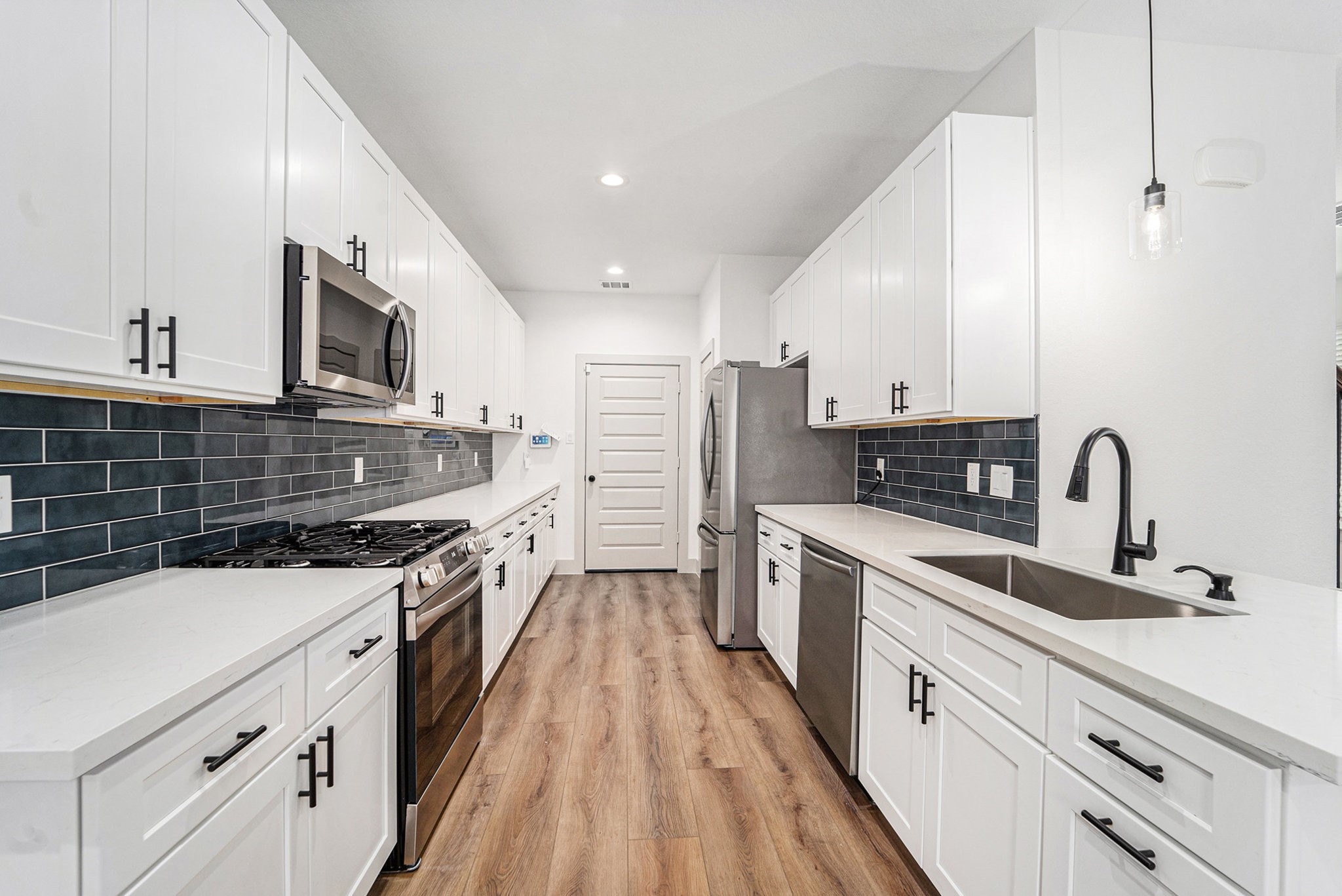 6425 Anderson Road, Unit B Houston, TX 77085 - Photo 12 of 36 a kitchen with stainless steel appliances a sink dishwasher stove refrigerator and microwave