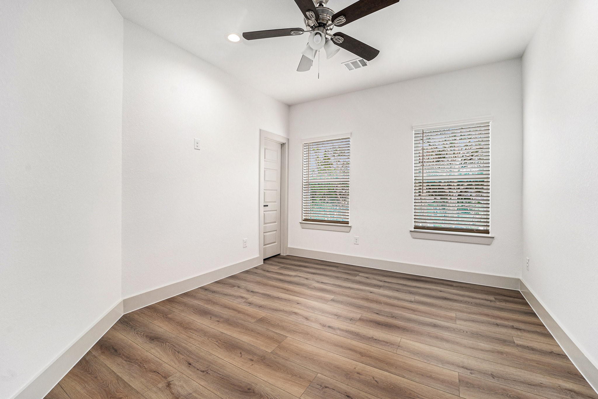 6425 Anderson Road, Unit B Houston, TX 77085 - Photo 29 of 36 a view of an empty room with wooden floor and a window