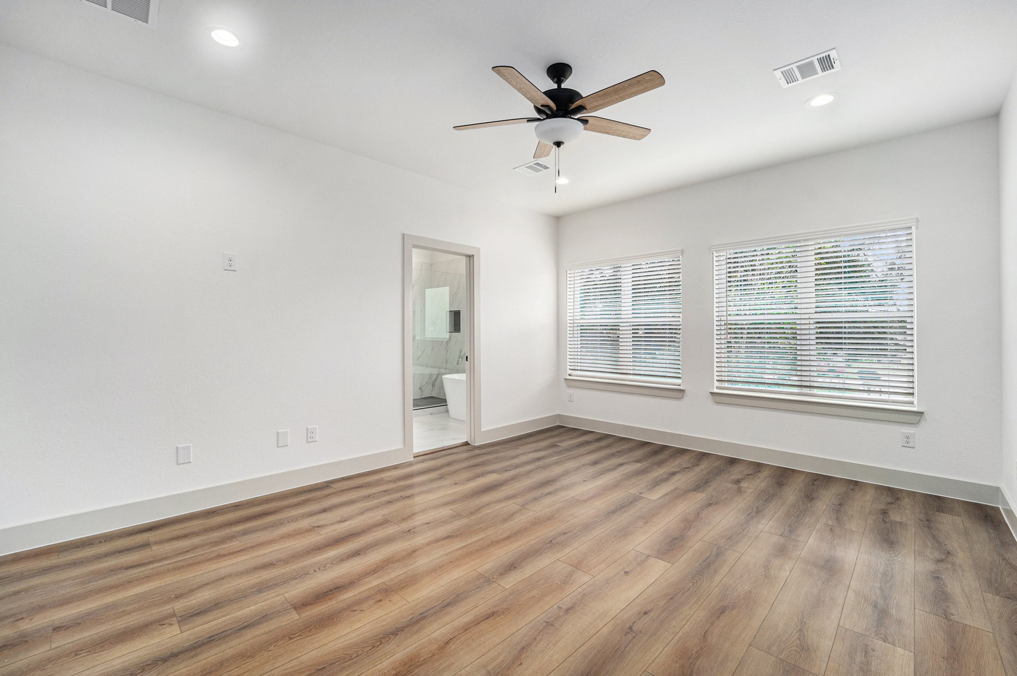 6425 Anderson Road, Unit B Houston, TX 77085 - Photo 31 of 36 an empty room with wooden floor and windows