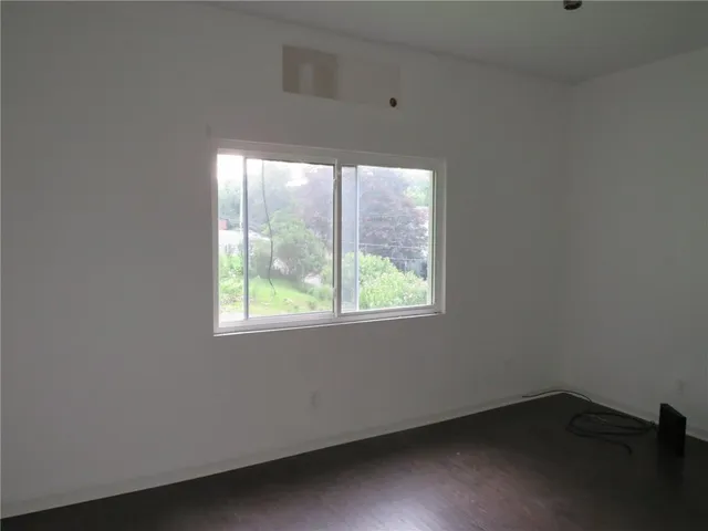 a view of an empty room and wooden floor