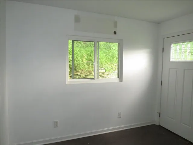 a view of an empty room with closet