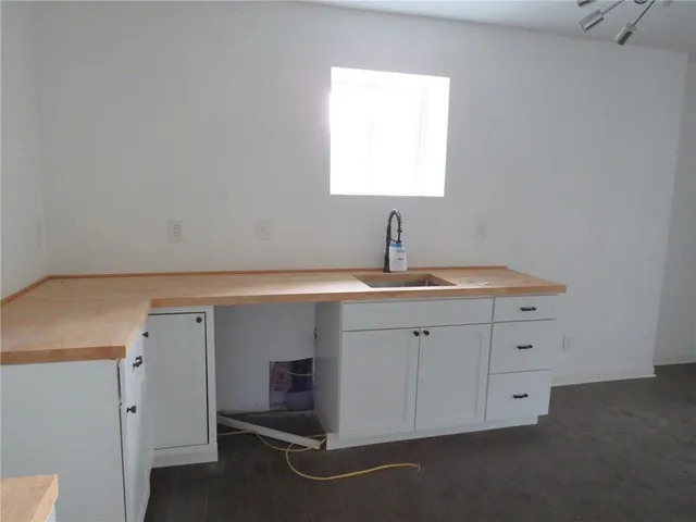 a room with a sink and cabinets