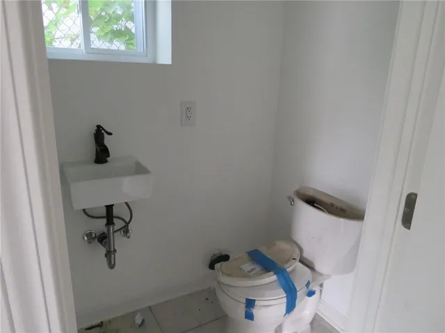 a bathroom with a toilet and a window