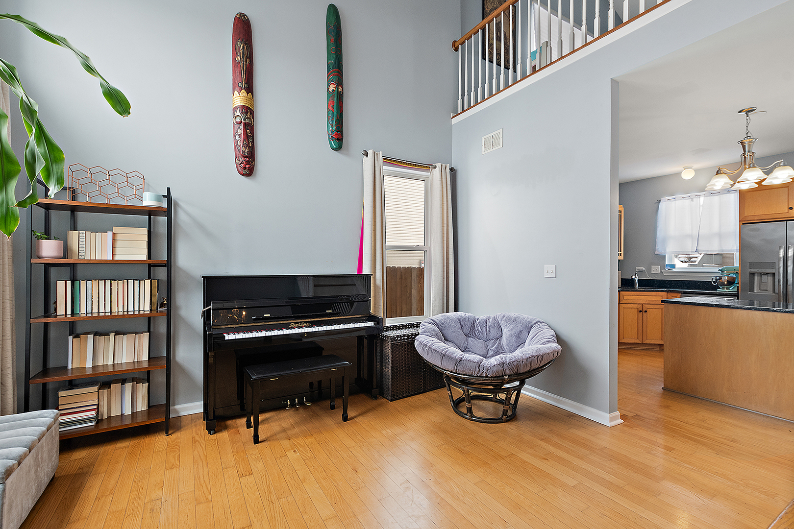 420 Wilshire Lane Bolingbrook, IL 60440 - Photo 3 of 41 a living room with a piano and a bookshelf