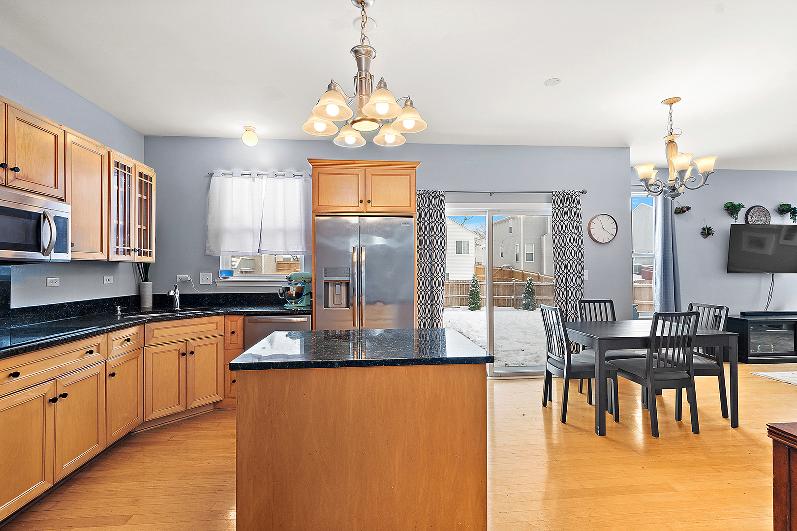 420 Wilshire Lane Bolingbrook, IL 60440 - Photo 6 of 41 a large kitchen with granite countertop a large counter top a sink stainless steel appliances and cabinets