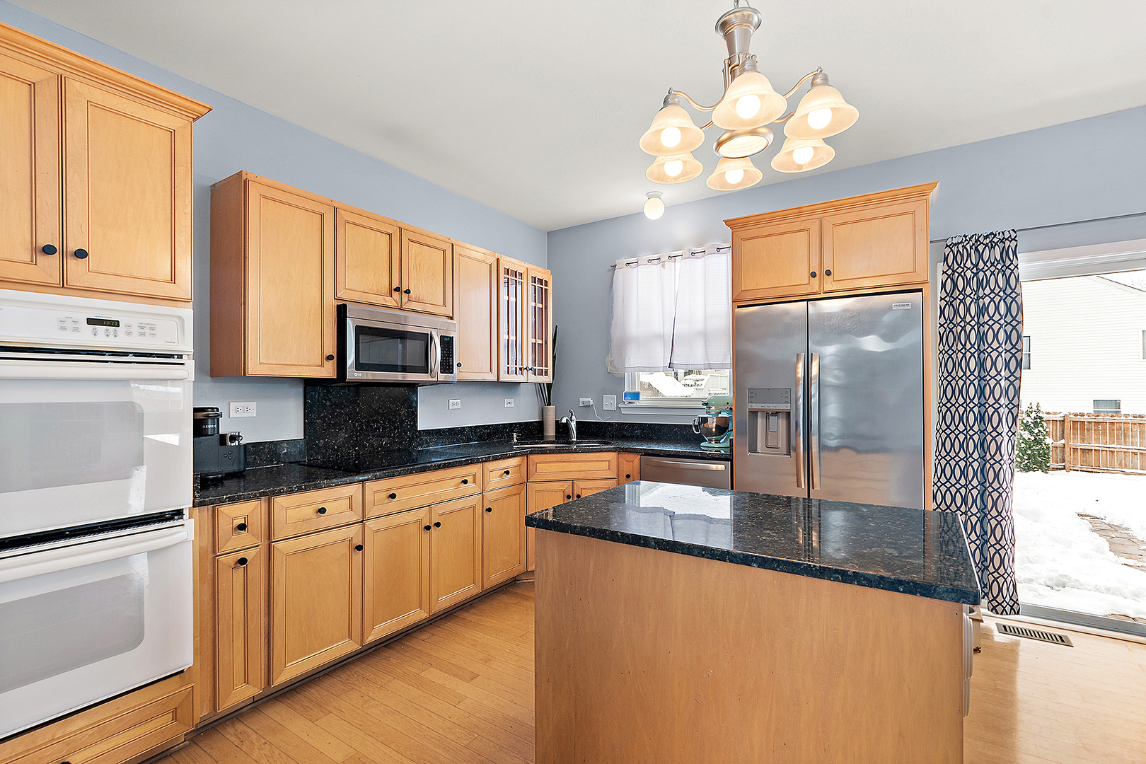 420 Wilshire Lane Bolingbrook, IL 60440 - Photo 8 of 41 a kitchen with stainless steel appliances granite countertop a stove a sink dishwasher and a refrigerator with wooden floor