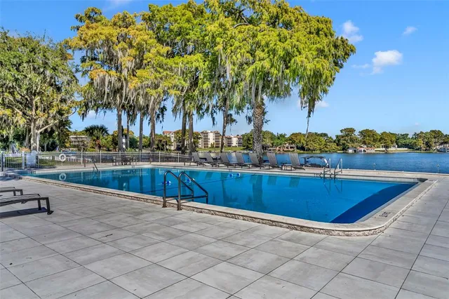 a view of swimming pool with outdoor seating and plants