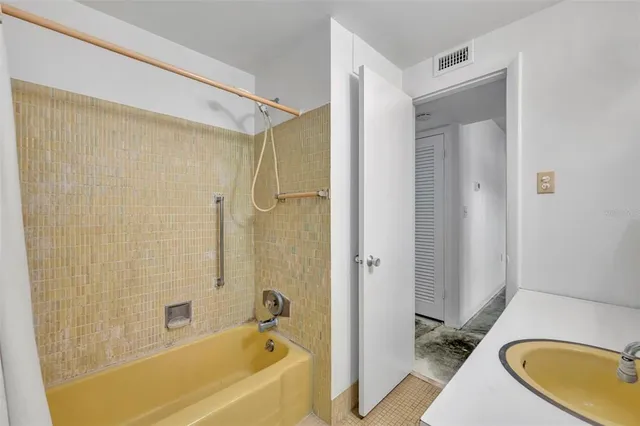 a bathroom with a tub and a sink