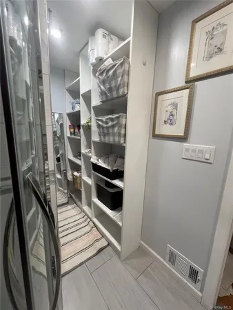 a view of a hallway with stairs and furniture