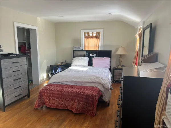 a bedroom with a bed and a dresser