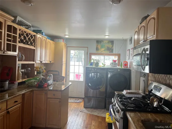 a kitchen with stainless steel appliances granite countertop a stove refrigerator and cabinets