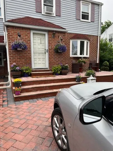a backyard of a house with barbeque oven table and chairs