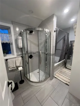 a bathroom with a shower and a mirror