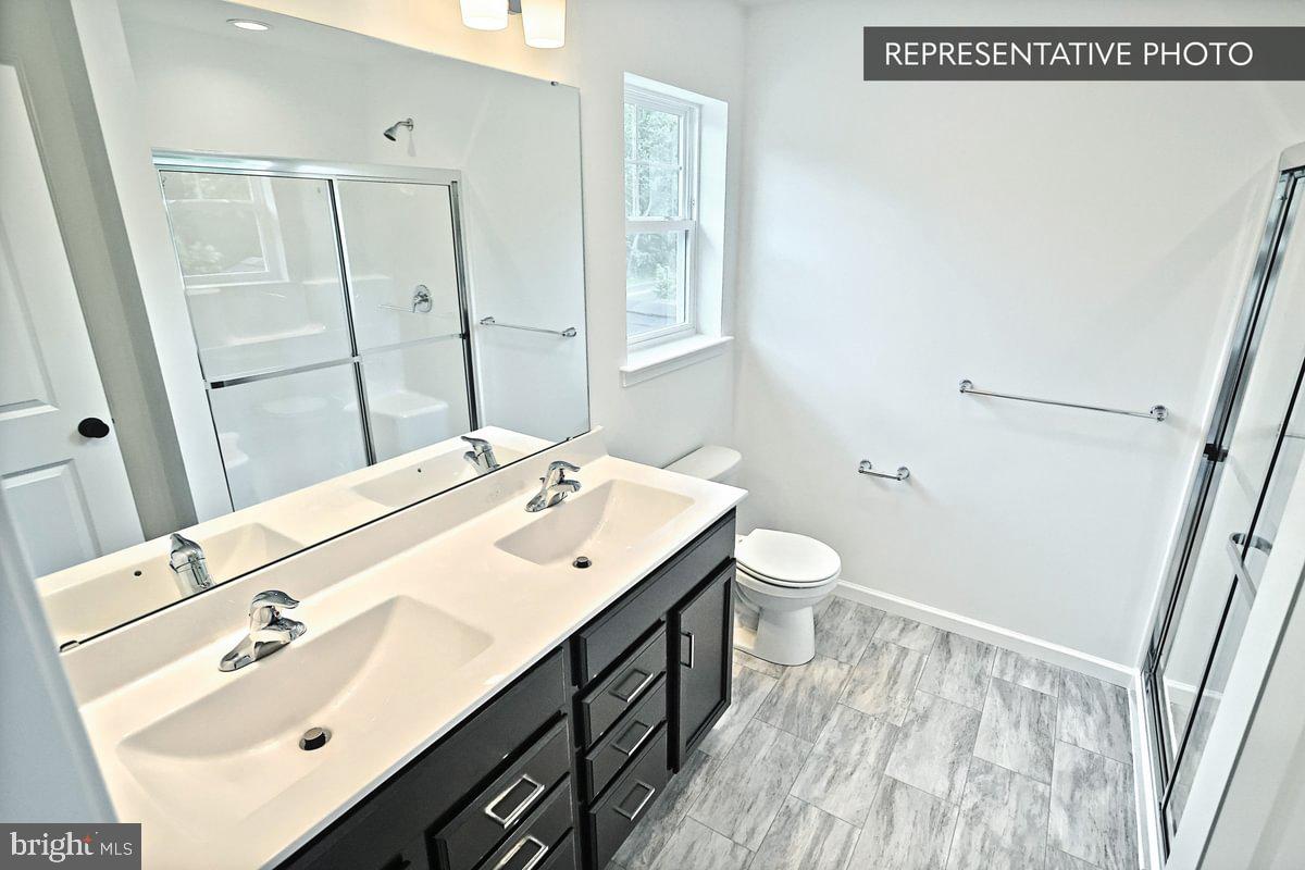 Emily Plan At Hills Spring Grove, PA 17362 - Photo 22 of 26 a bathroom with a sink a toilet and mirror