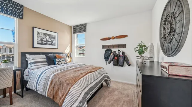 a bedroom with bed and a mirror