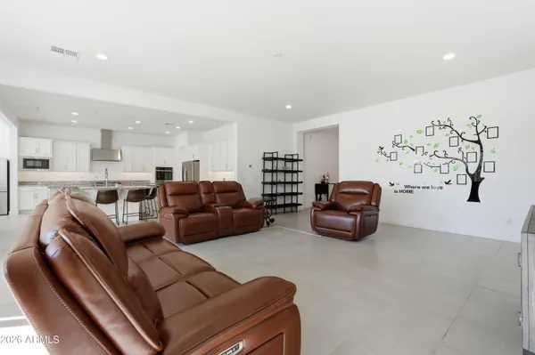 a kitchen with kitchen island granite countertop stainless steel appliances cabinets a sink and a island