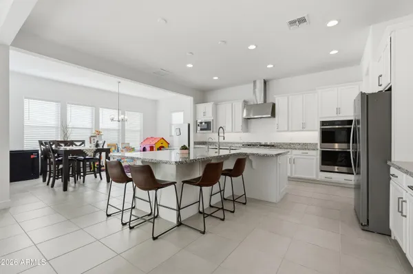 a living room with furniture and wall paintings