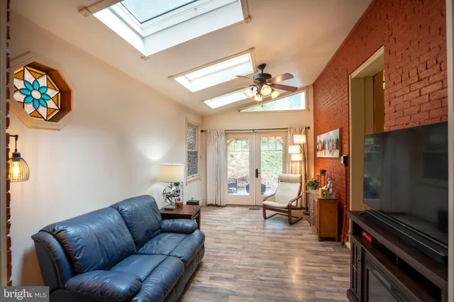a kitchen with granite countertop a sink a counter top space and stainless steel appliances