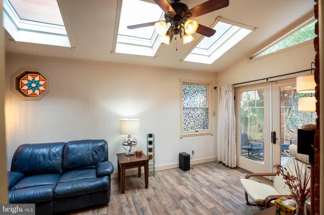 a kitchen with granite countertop white cabinets and stainless steel appliances