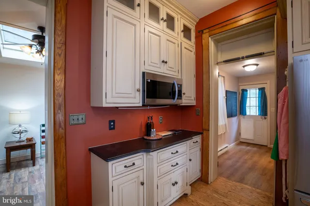 a view of entryway with wooden floor and windows