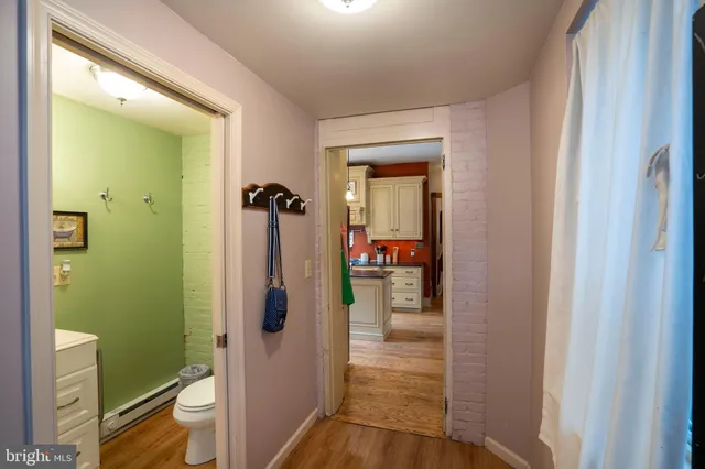 a bedroom with a large bed a flat tv screen and dresser