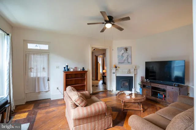 a view of living room with furniture and wooden floor