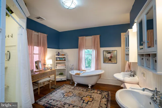 a view of entryway and hall with wooden floor