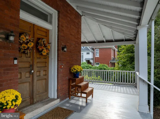 a living room with furniture a fireplace and a chandelier