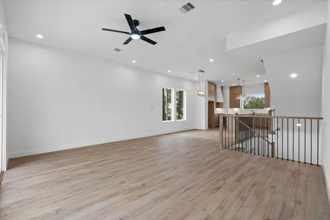 a view of a livingroom with a hardwood floor and a ceiling fan