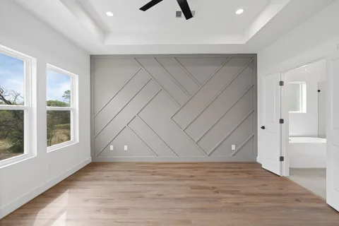 an empty room with window and wooden floor