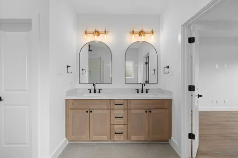 a bathroom with double sink and a mirror